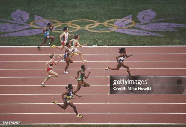 Gail Devers of the United States strides away from Mary Onyali of Nigeria, Debbie Ferguson of the Bahamas and the field to win her heat in the...