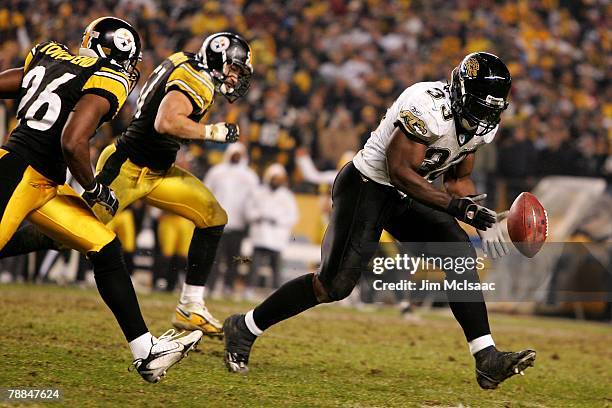 Greg Jones of the Jacksonville Jaguars loses control of the ball as he is pursued by Deshea Townsend and James Farrior of the Pittsburgh Steelers...