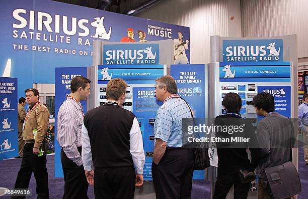 Attendees visit the Sirius Satellite Radio booth at the 2008 International Consumer Electronics Show at the Las Vegas Convention Center January 9,...