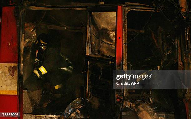 An Italian firefighter checks the truck of their collegues burned by demonstrators during protests against against the Pianura dump in Monteruscello...