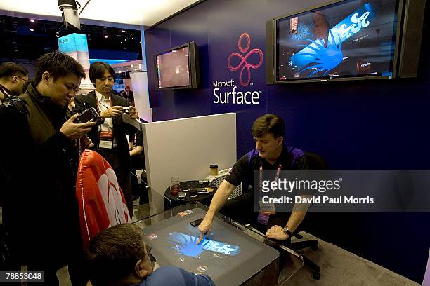 Microsoft employee shows people the new Microsoft Surface at the 2008 International Consumer Electronics Show at the Las Vegas Convention Center...