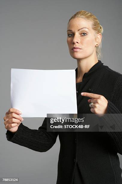 businesswoman pointing at blank sign - rf business stock-fotos und bilder