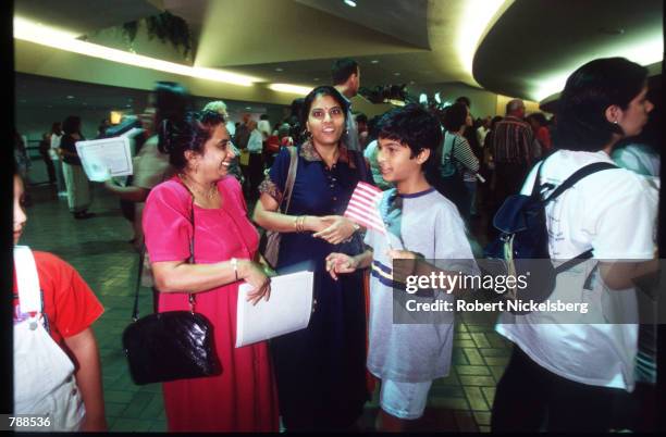 An Indian family stands September 25, 1999 in Miami, FL. Three thousand people attended the swearing in ceremony and took the Oath of Allegiance...