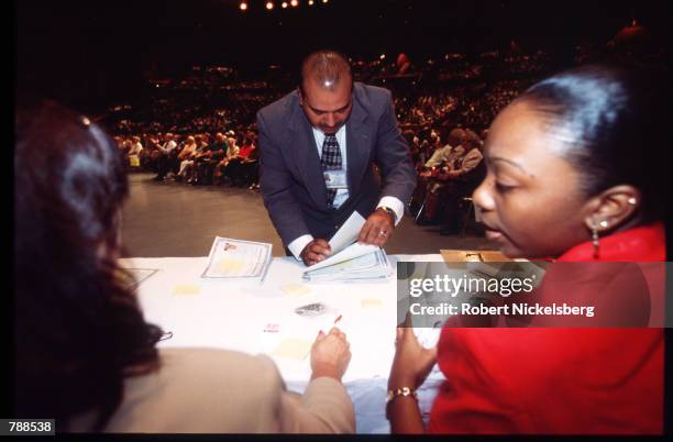 An unidentified man looks through citizenship certificates September 25, 1999 in Miami, FL. Three thousand people attended the swearing in ceremony...