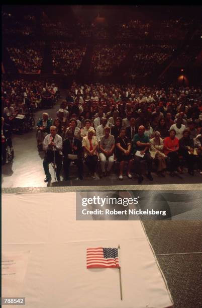 Individuals wait for the swearing in ceremony to start September 25, 1999 in Miami, FL. Three thousand people attended the swearing in ceremony and...