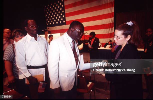 New citizens receive their naturalization certificates after the ceremony September 25, 1999 in Miami, FL. Three thousand people attended the...