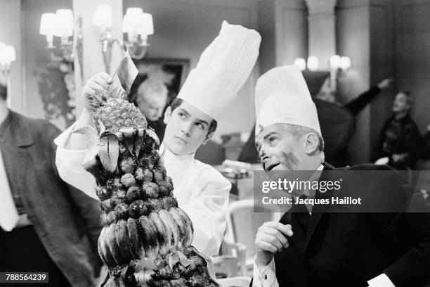 French actor Louis de Funes and his son, actor Olivier de Funes on the set of Le Grand Restaurant , written and directed by Jacques Besnard.