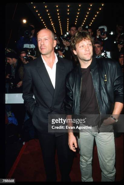 Bruce Willis and Jon Bon Jovi pose October 10, 1999 at the Ziegfeld Theatre in New York City. They attend the premiere of the film "The Story Of Us."