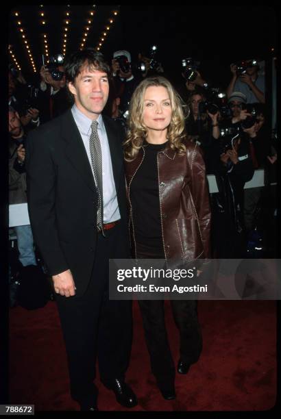 David E.Kelley and Michelle Pfeiffer pose October 10, 1999 at the Ziegfeld Theatre in New York City. They attend the premiere of the film "The Story...