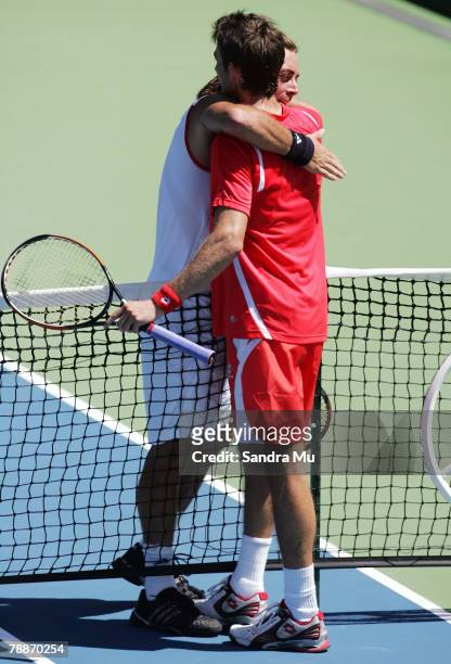 Nicolas Massu of Chile congratulates Juan Carlos Ferrero of Spain at the end of their match during day four of the Heineken Open at the ASB Bank...