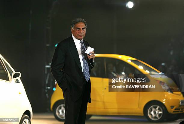Chairman of India's giant Tata Group Ratan Tata poses in front of the Tata "Nano" car during the launch in New Delhi, 10 January 2008. India's giant...