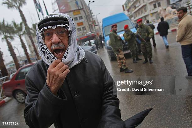 An elderly Palestinian man expresses his disdain for US President George W. Bush, calling him a "Hitler", as Palestinian police close the roads...