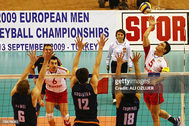 Francisco Rodriguez of Spain smashes the ball towards the block of Christian Cornalis van der Wel Wytze Kooistra and Jeroen Paul Trommel during their...