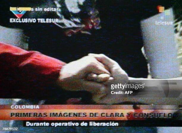 Grab from Venezuelan channel Telesur of Colombian politician Clara Rojas?s hand being held by Venezuelan Interior and Justice Minister Ramon...