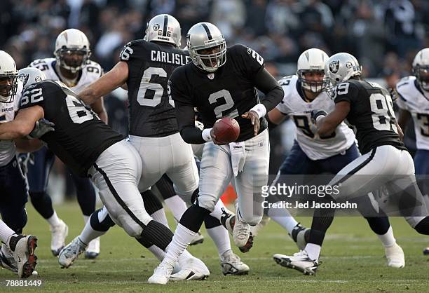 JaMarcus Russell of the Oakland Raiders hands off the ball during an NFL game against the San Diego Chargers on December 30, 2007 at McAfee Coliseum...