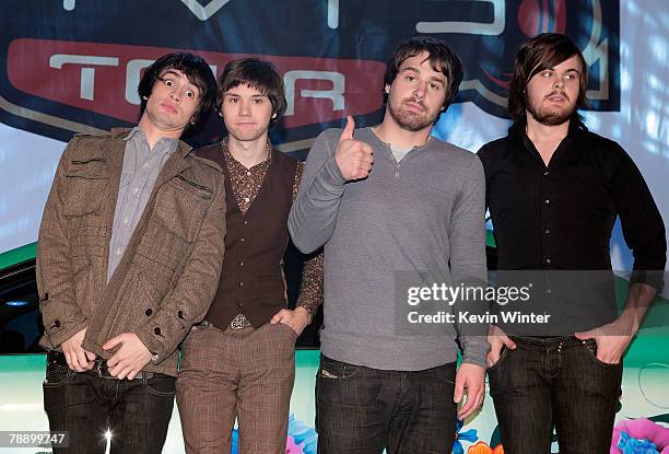 Members of the band Panic! at the Disco frontman Brendon Urie, guitarist Ryan Ross, bassist Jon Walker and drummer Spencer Smith pose onstage during...