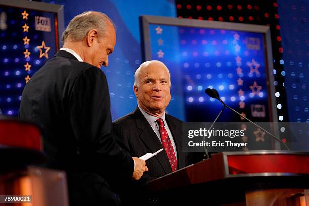 Republican presidential hopefuls former U.S. Sen. Fred Thompson and Sen. John McCain interact following a televised debate at the Myrtle Beach...