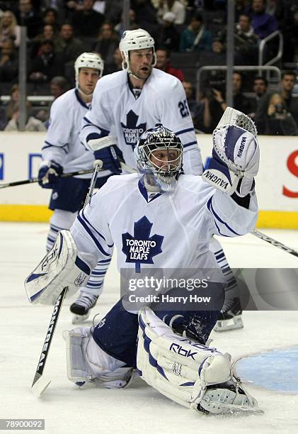 Vesa Toskala of the Toronto Maple Leafs looks back for a puck with Hal Gil on a goal scored by Rob Blake of the Los Angeles Kings during the second...