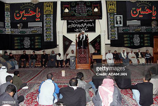 Shiite believers listen to a preacher during a mourning gathering in the Bahraini capital Manama 10 January 2008, on the occasion of Ashoura which...
