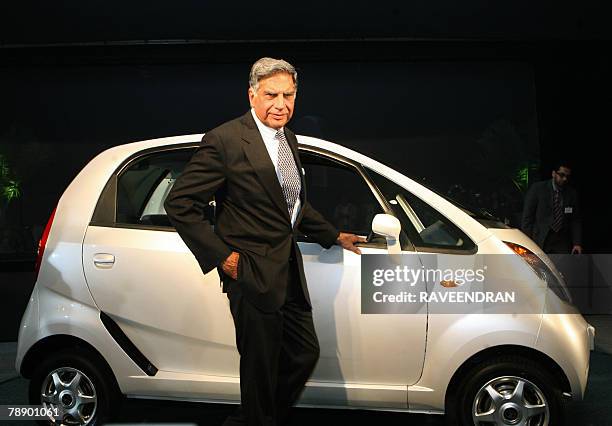 Chairman of India's giant Tata Group Ratan Tata poses in front of the Tata "Nano" car during the launch in New Delhi, 10 January 2008. India's giant...