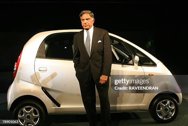 Chairman of India's giant Tata Group Ratan Tata poses in front of the Tata "Nano" car during the launch in New Delhi, 10 January 2008. India's giant...