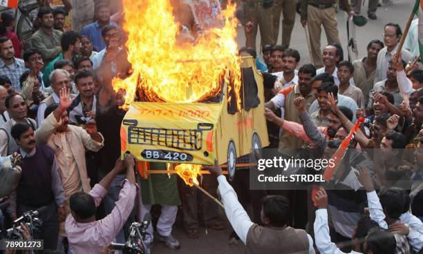 Activists of the Trinamool Congress-led 'Krishi Jami Raksha Committee' burn an effigy of the Tata Motors' ambitious people's car 'Nano' during a...