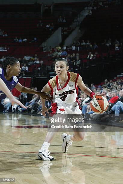 Tully Bevilaqua of the Portland Fire drives past Kedra Holland-Corn of the Sacramento Monarchs during the WNBA game at the Rose Garden in Portland,...