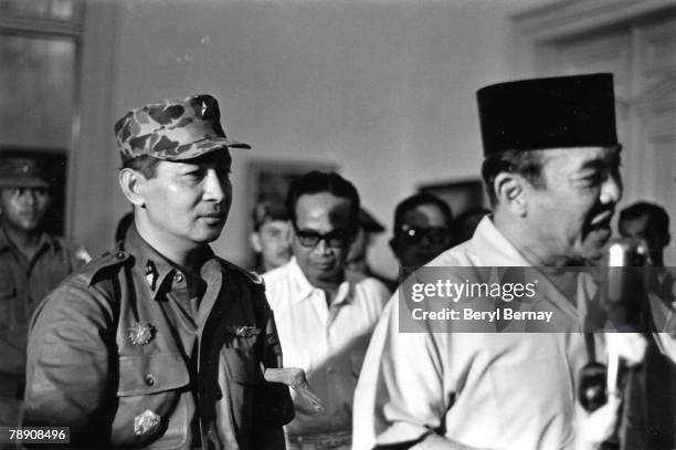 President Sukarno of Indonesia walks with the Major General Suharto March 11, 1966 in Idonesia. Sukarno, was obliged by the Indonesia Army to give...