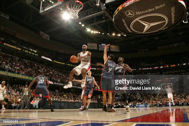 LeBron James of the Cleveland Cavaliers drives in for the layup against the Charlotte Bobcats at the Quicken Loans Arena January 11, 2008 in...