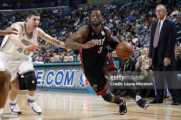 Dwyane Wade of the Miami Heat drives past Ryan Bowen of the New Orleans Hornets on January 11, 2008 at the New Orleans Arena in New Orleans,...