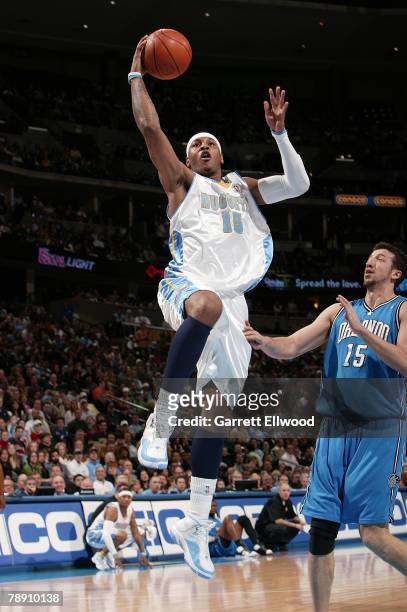 Carmelo Anthony of the Denver Nuggets goes to the basket against Hedo Turkoglu of the Orlando Magic at the Pepsi Center January 11, 2008 in Denver,...