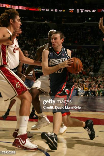 Matt Carroll of the Charlotte Bobcats drives to the basket against Anderson Varejao of the Cleveland Cavaliers at the Quicken Loans Arena January 11,...