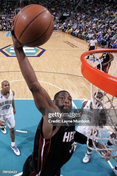 Dwyane Wade of the Miami Heat dunks over David West and Chris Paul of the New Orleans Hornets on January 11, 2008 at the New Orleans Arena in New...