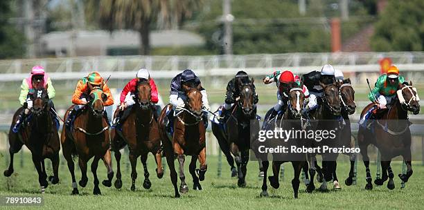 Dean Holland riding Lucky Diva leads the field in the Robert Taranto Handicap during the Rubiton Stakes Day held at Caulfield Racecourse January 12,...