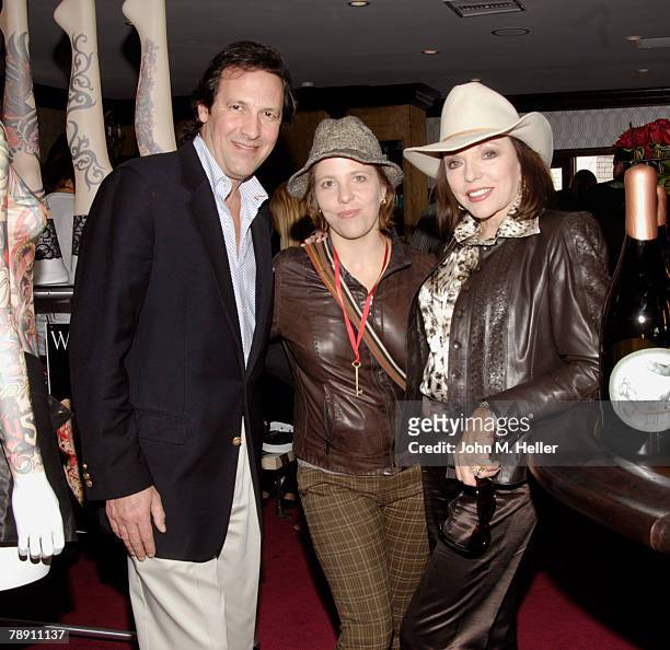 Percy Gibson, Katy Kass and Joan Collins attends the Secret Room Celebrity Gifting Suite Day 2 for the 66th Annual Golden Globe Awards at Metro...