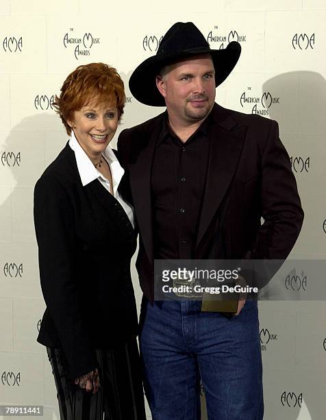 Reba McEntire and Garth Brooks pose for photographers at the 29th Annual American Music Awards at the Shrine Auditorium in Los Angeles.