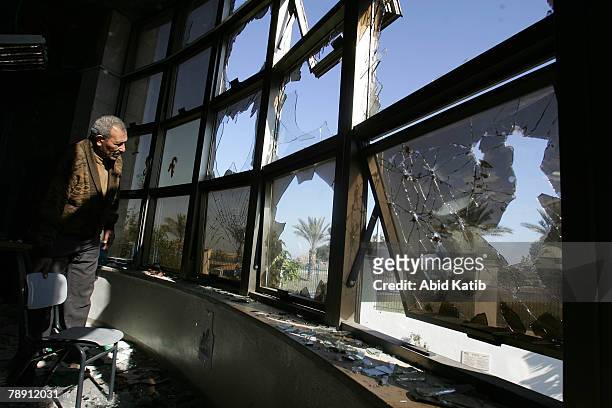 Palestinian man inspects the art class room of an American school, after it was destroyed by unknown gunmen, on January 12, 2008 in Beit Lahia,...