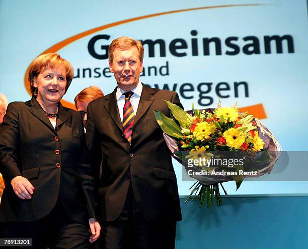 Christian Wulff of the Christian Democratic Union , top candidate and Governor of Lower Saxony and German Chancellor Angela Merkel look on during the...