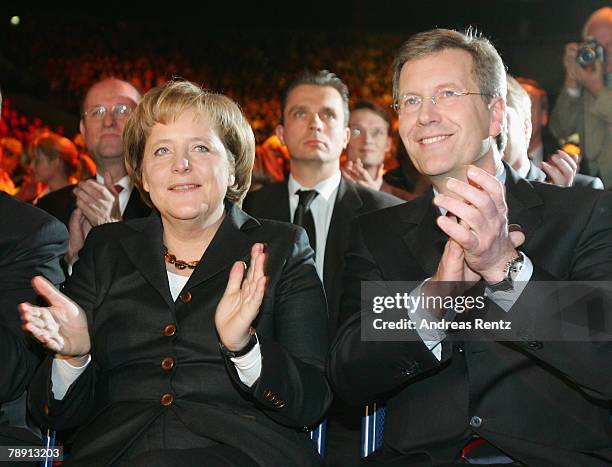 Christian Wulff of the Christian Democratic Union , top candidate and Governor of Lower Saxony and German Chancellor Angela Merkel gesture during the...