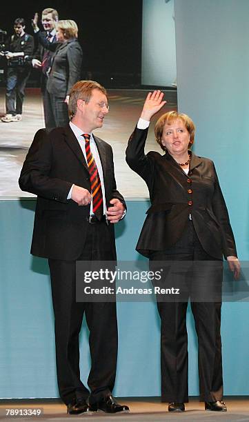 Christian Wulff of the Christian Democratic Union , top candidate and Governor of Lower Saxony and German Chancellor Angela Merkel wave during the...