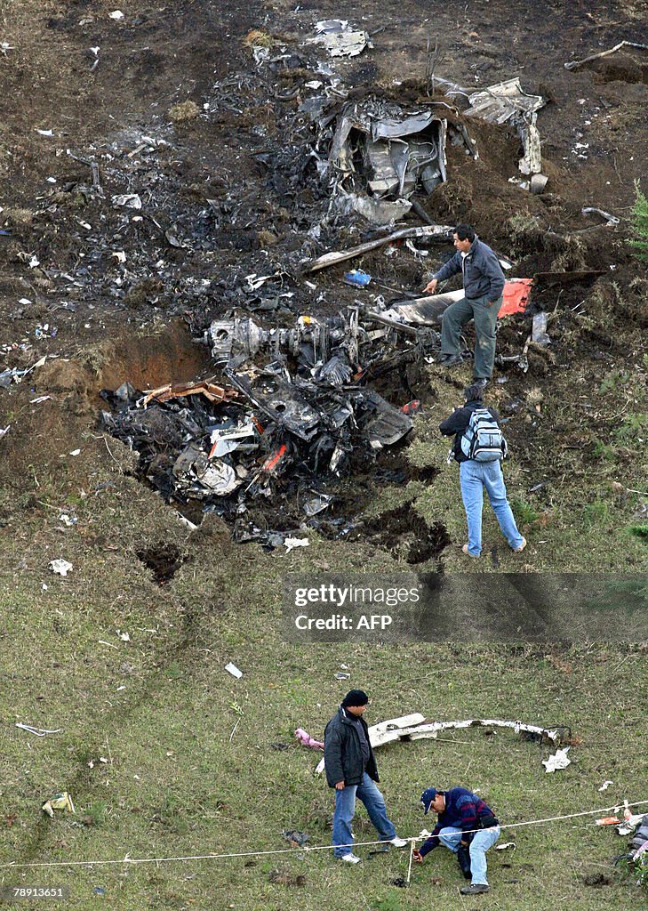 Rescuers see the remains of a helicopter