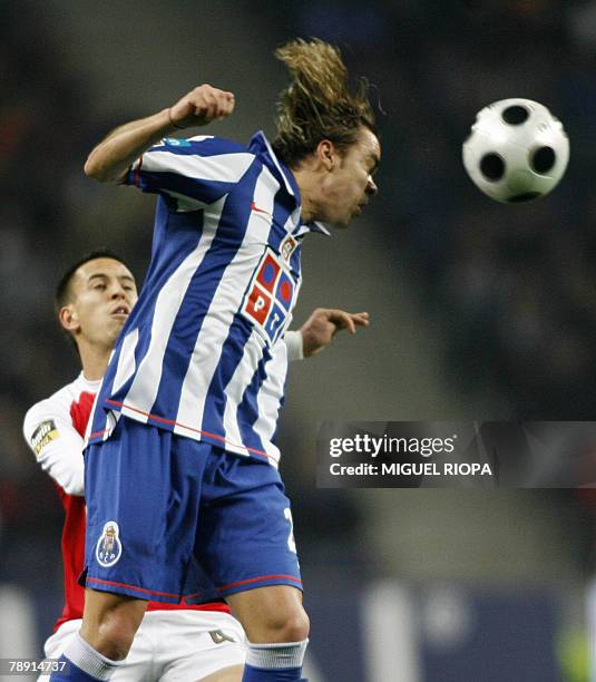 Porto's Brazilian Adriano Louzada heads the ball next to SC Braga's Joao Pereira during their portuguese Super League football match at the Dragao...