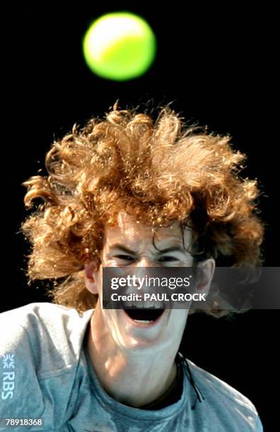 British tennis player Andy Murray watches the ball after playing a stroke during a practice session in Melbourne, 13 January 2008, on the eve of the...