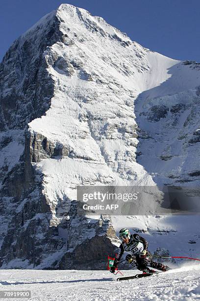 Ski racer Bode Miller passes a curve with the north face of the Eiger mountain as background on his way to win in the Men's FIS Alpine World Cup...