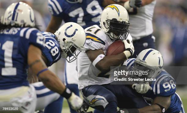 LaDainian Tomlinson of the San Diego Chargers runs the ball against Robert Mathis and Marlin Jackson of the Indianapolis Colts during their AFC...