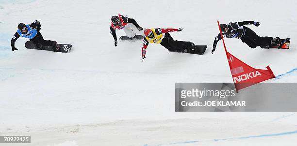 Jonathan Cheever of US, France's Ludovic Guillot-Diat, Canada's Tom Velisek and Austria's Hans-Joerg Unterrainer compete on the Snowboard Cross at...