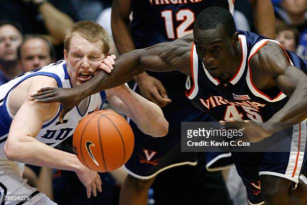 Solomon Tat of the Virginia Cavaliers battles for a loose ball against Kyle Singler of the Duke Blue Devils during the second half at Cameron Indoor...