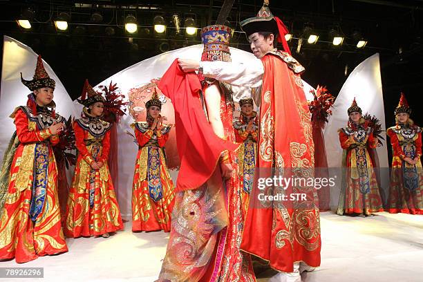 Chinese models parade the various costumes as they reenact a lavish Mongolian wedding ceremony during a fashion show in Beijing 13 January 2008....