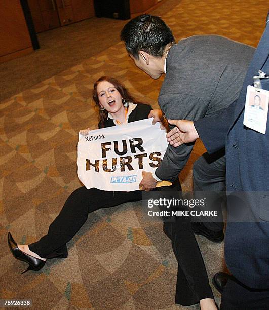 Activists from People for the Ethical Treatment of Animals hold a demonstration at the Hong Kong Fashion Week after disrupting a seminar on "Let Fur...