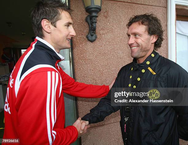 Miroslav Klose of Munich shake hands with Dortmund?s head coach Thoams Doll prior to the Bayern Munich training session on January 14, 2008 in...